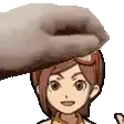 a hand is holding a cartoon character 's head .