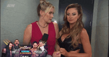 two women are standing next to each other in front of a sign that says aew dynamic