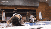two women are wrestling in a ring with a sign that says stardom