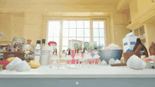 a kitchen counter with a jar of flour and a bowl of sugar