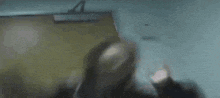 a blurry picture of a woman standing in front of a door .