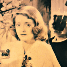 a black and white photo of a woman in a dress