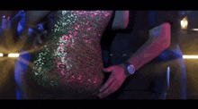 a woman in a sequined dress is dancing on a stage