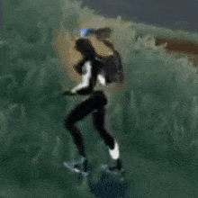 a person with a backpack is walking through a grassy field