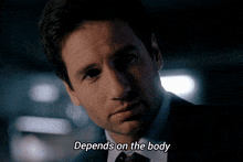 a close up of a man 's face with the words depends on the body below him