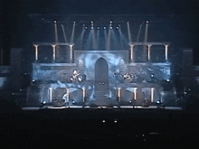 a group of people are playing instruments on a stage in front of a door