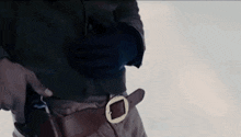 a close up of a person holding a gun in their pocket .