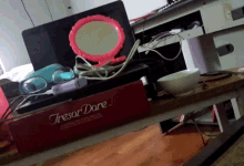 a trésor dare box sits on a messy table