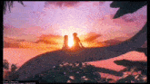 a man and a woman are sitting on top of a tree watching the sunset .