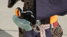 a person is wearing a belt with a snake buckle