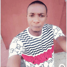 a man wearing a black and white striped shirt with gucci on the sleeves