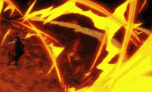 a man is standing in front of a huge fire .