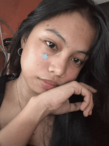 a young girl with a blue star on her face