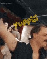 a man with a mustache is dancing in front of a sign that says tuppiii