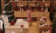 a little girl standing in front of a christmas tree