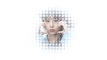 a woman in a blue plaid shirt is making a heart with her hands