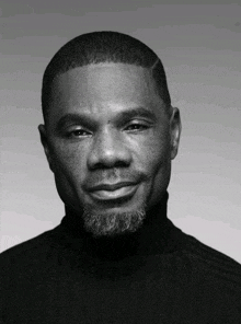 a black and white photo of a man with a turtleneck