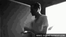 a black and white photo of a man with the words make gifs at gifsoup.com underneath him
