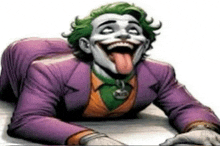 the joker is sticking his tongue out while laying on the floor .