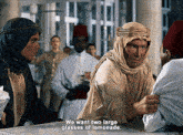 a man in a turban is talking to another man and says we want two large glasses of lemonade