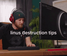 a man wearing headphones sits in front of an lg computer