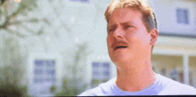 a man with a mustache is making a sad face