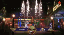 a man is dancing in front of a big boss sign