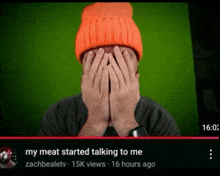 a man wearing an orange hat is covering his face with his hands and the caption says my meat started talking to me