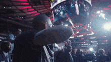 a man wearing a black shirt that says ' nike ' on it stands in front of a crowd of people