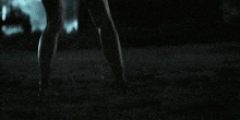 a person 's feet are visible in the dark in a blurry photo