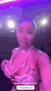 a woman taking a selfie with a purple background and a snapchat icon