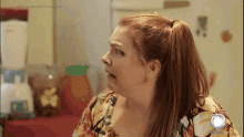 a woman with a ponytail looks at something in front of a refrigerator that says programa do porchat
