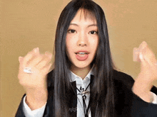 a woman with long black hair is wearing a white shirt and black tie