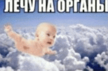 a baby is floating in the clouds with a russian text behind it .