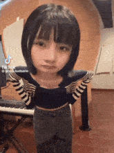 a tiktok of a girl standing in front of a keyboard