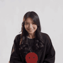 a woman with long black hair is smiling with her mouth open
