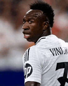 a soccer player with the name vini jr on the back of his shirt