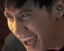 a close up of a man 's face with a smile