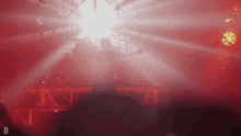 a blurred image of a stage with the letter d on the bottom right