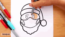 someone is drawing a santa wearing a face mask