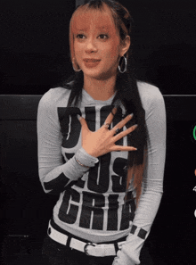 a woman with pink hair is wearing a shirt that says do us grit