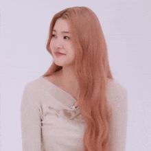 a woman with long red hair is smiling and wearing a white shirt that says disney on it