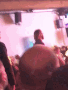 a blurry picture of a group of people sitting in a dark room