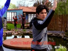 a poster for cobra kai 's valley rising shows a man doing karate