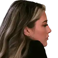 a close up of a woman 's face with earrings in her ears