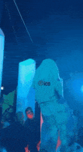 a group of people are standing around a large statue of a polar bear .