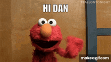 elmo from sesame street is waving and saying hi dan