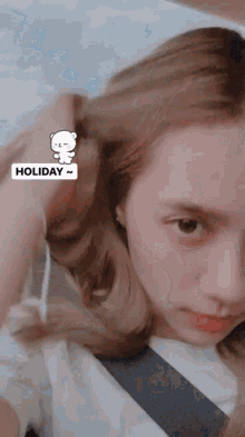 a close up of a woman 's face with a holiday sticker on her hair
