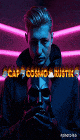 a man is holding a mask in front of a sign that says cap cosmo rustic
