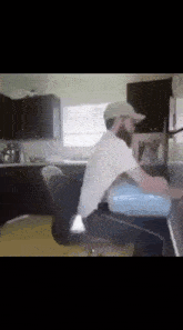 a man sitting at a counter in a kitchen